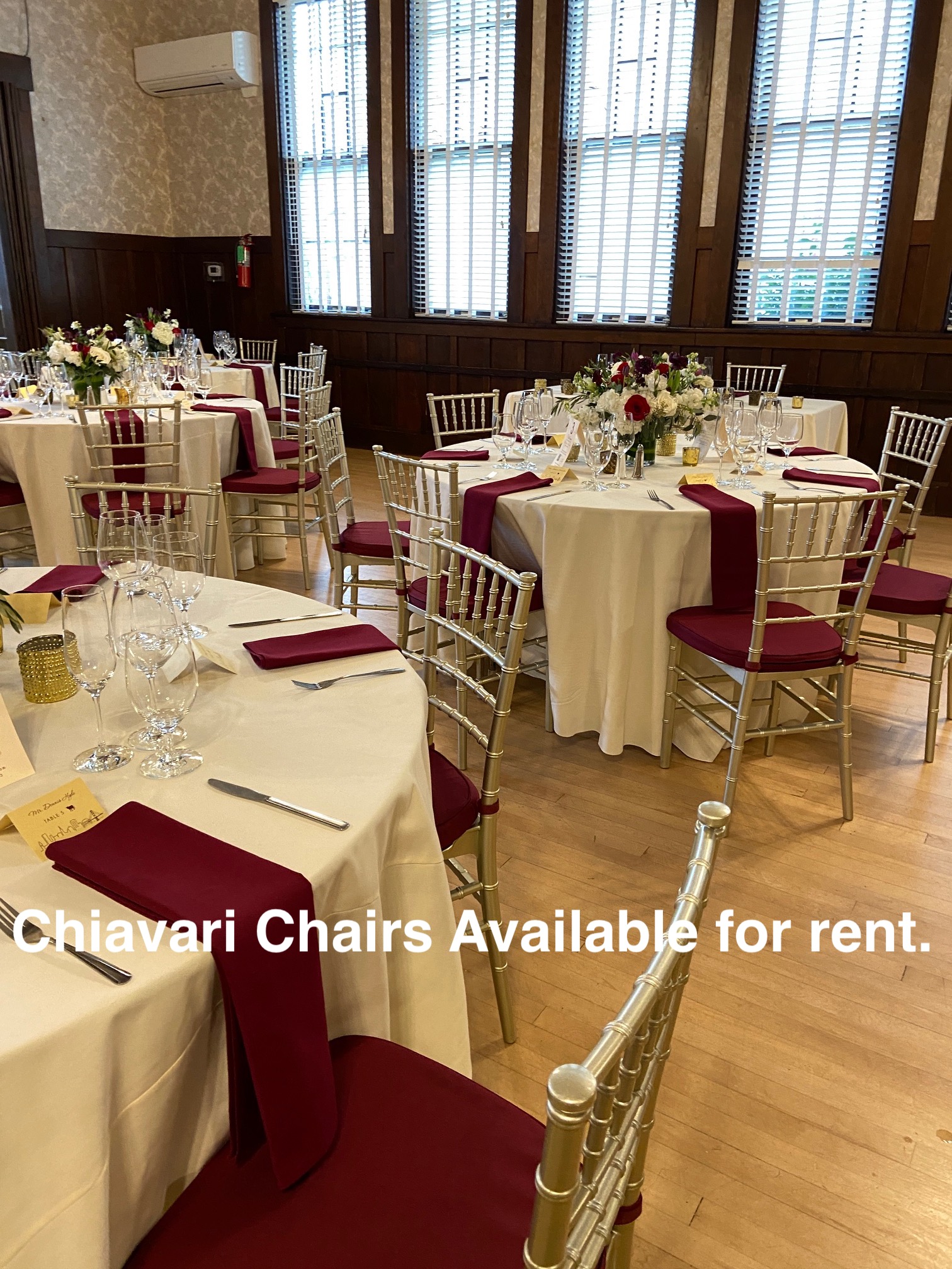 Clubhouse decorated for wedding with rented Chiavari chairs.