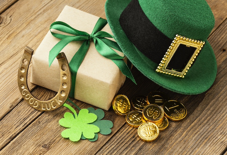 St. Patrick's day green hat, good luck hourseshoe, gold coins, shamrocks, and a present with green ribbon.