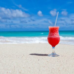 Tropical drink on white sand beach