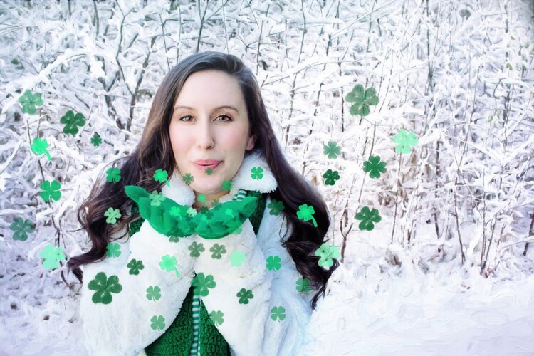 Woman in snow blowing shamrock kisses