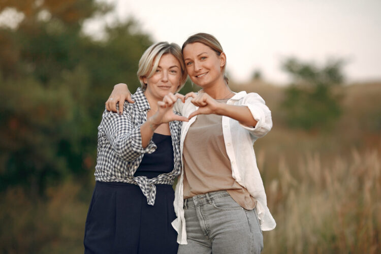 Women in a autumn wheat field hugging