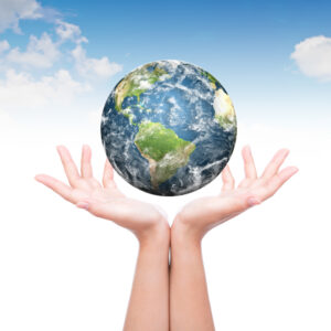 pair of hands holding up planet earth.